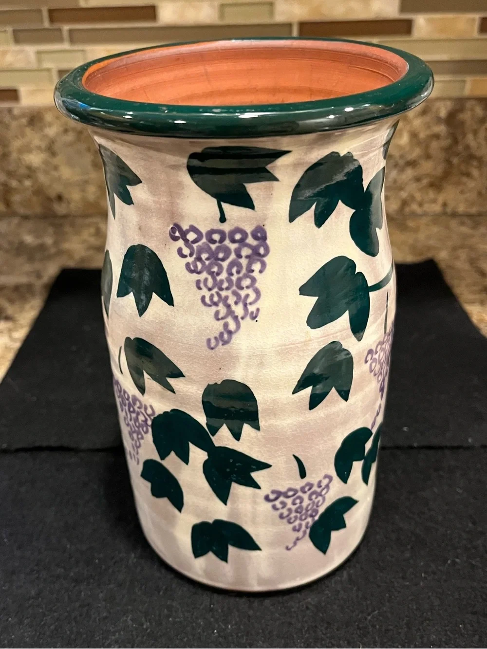 Handmade pottery vase cream-colored with a green and purple grape vine motif